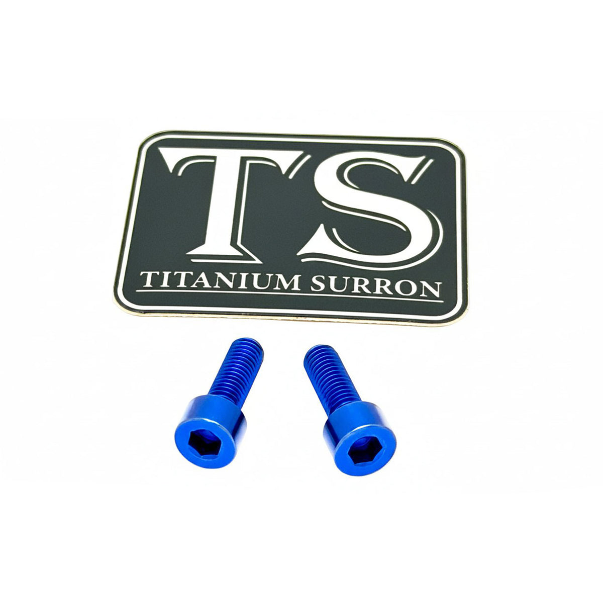 Two blue anodized hex head screws placed below a black rectangular badge with white lettering that reads 'TS TITANIUM SURRON' on a plain white background.