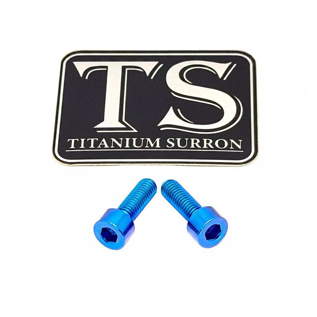 Two bright blue titanium hex bolts displayed below a black and white 'TS TITANIUM SURRON' brand logo plaque on a clean white background.