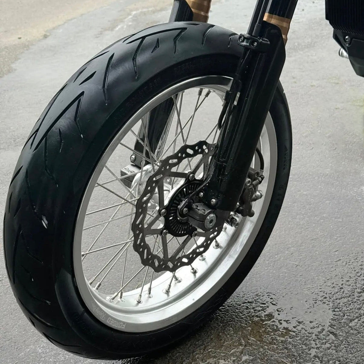 Sur-Ron Ultra Bee 17-inch supermoto wheel set in black and chrome finish - detail view