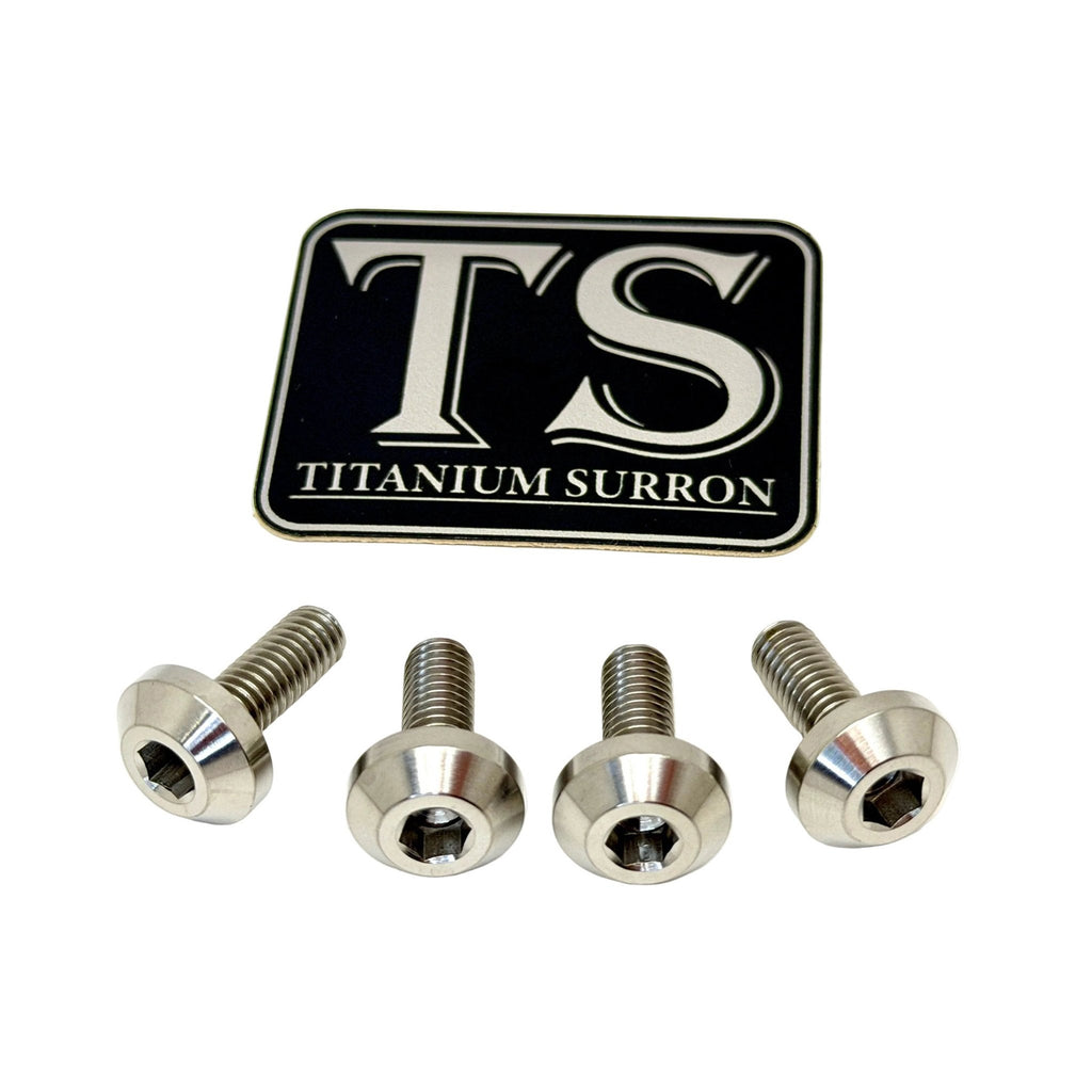 Four silver titanium surron screws arranged in a row below a black and silver TS Titanium Surron logo badge, on a plain white background.